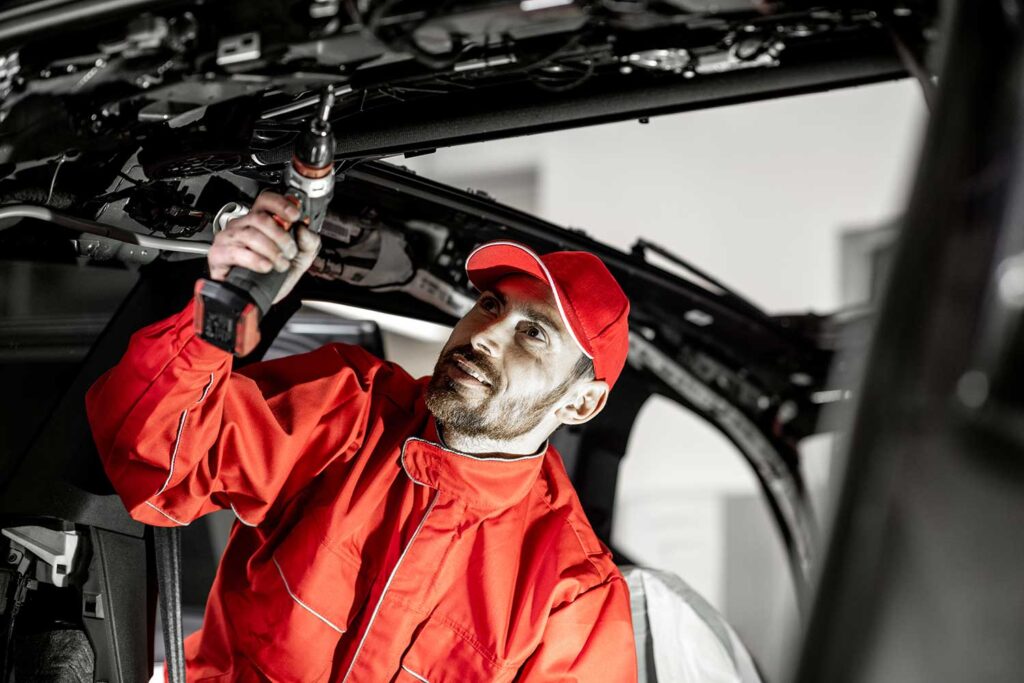 Worker disassembling car interior 2ECDQFR.jpg